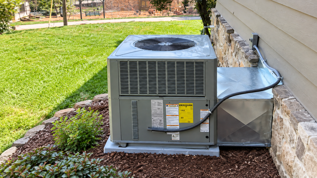 Residential HVAC package unit installed outdoors beside home